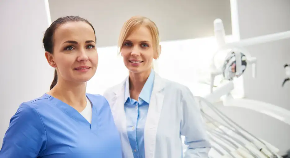 dental assistant in office with dentist