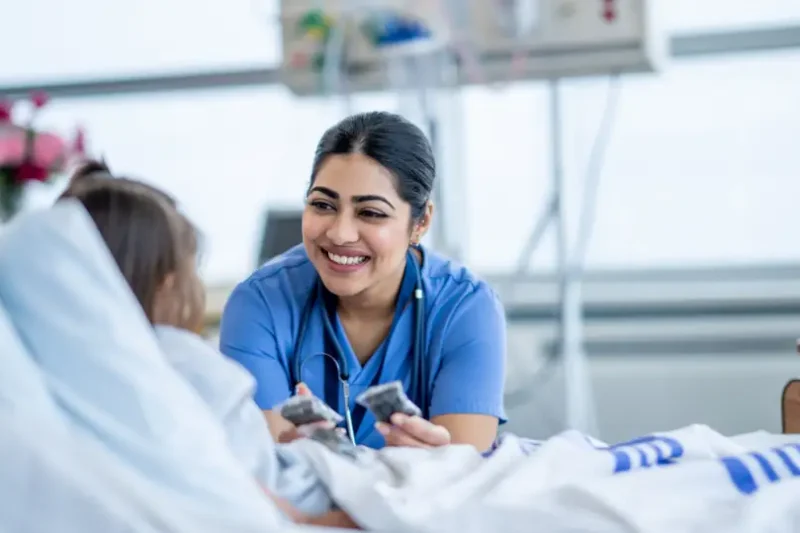 medical assistant helping patient